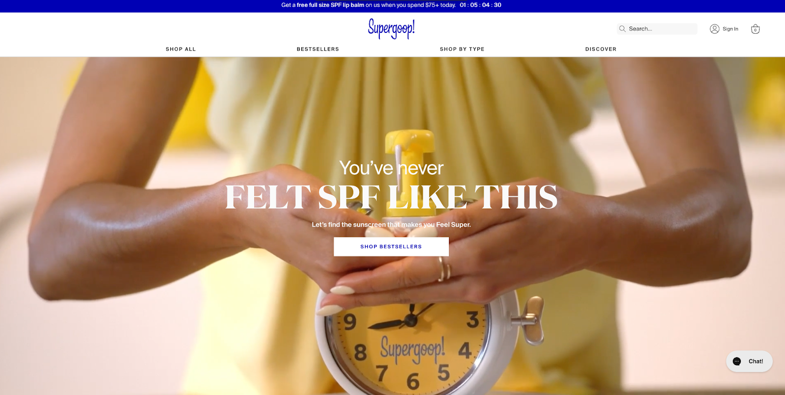 Screengrab of a background video with a woman’s hands pumping lotion on Supergoop’s homepage.
